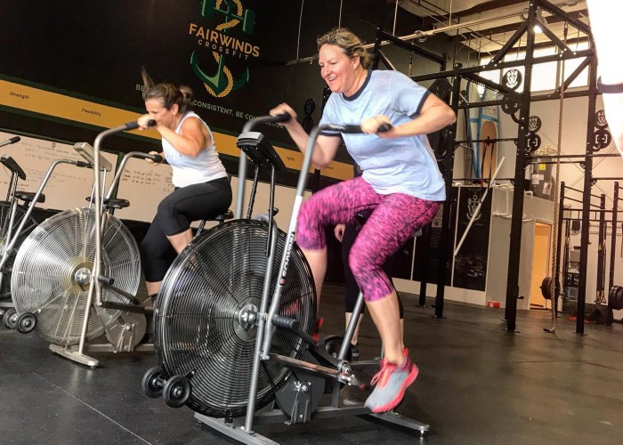 women working out on bikes in group fitness class